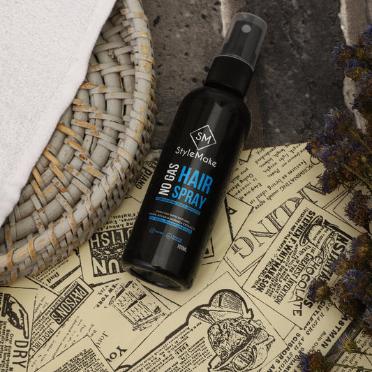 Black hair spray bottle labeled 'StyleMake' on a vintage-style newspaper background Hair building fiber, hair building fibre, hair fibers, hair fibres lock spray, hair lock spray, hair hold spray, hair fiber spray, hair locking spray, hair spary, hair spary, hair spray with moringa, onion, argan oil