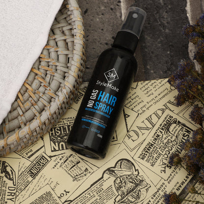 Black hair spray bottle labeled 'StyleMake' on a vintage-style newspaper background Hair building fiber, hair building fibre, hair fibers, hair fibres lock spray, hair lock spray, hair hold spray, hair fiber spray, hair locking spray, hair spary, hair spary, hair spray with moringa, onion, argan oil